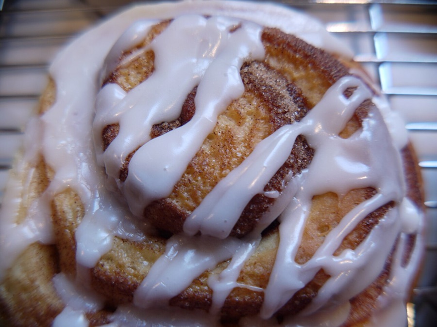 A cinnamon bun swirled deep and drizzled with frosting
