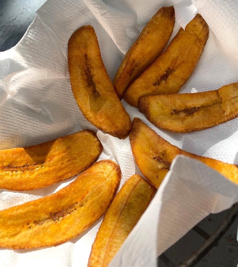 Fried ripe plantain slices draining on paper